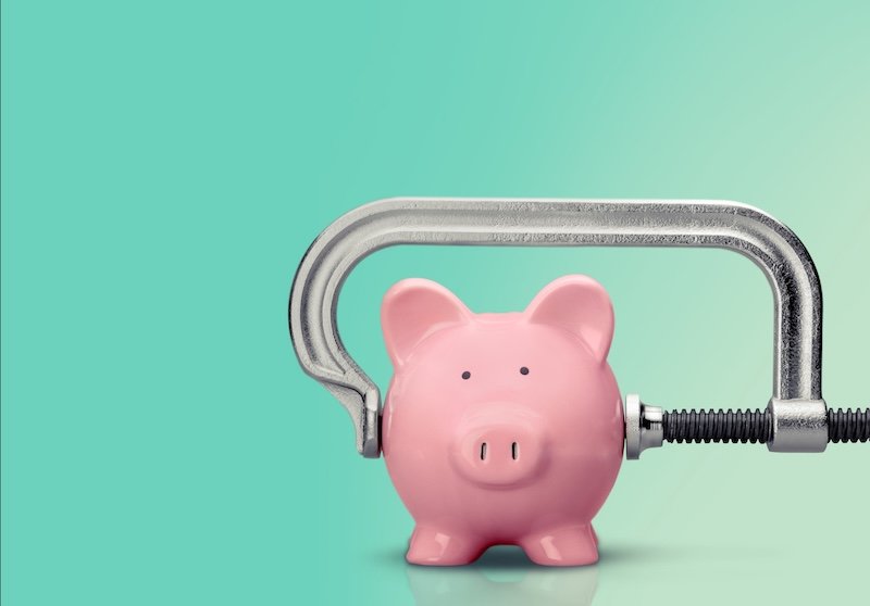 Cheap. Piggy bank with squeezing C clamp