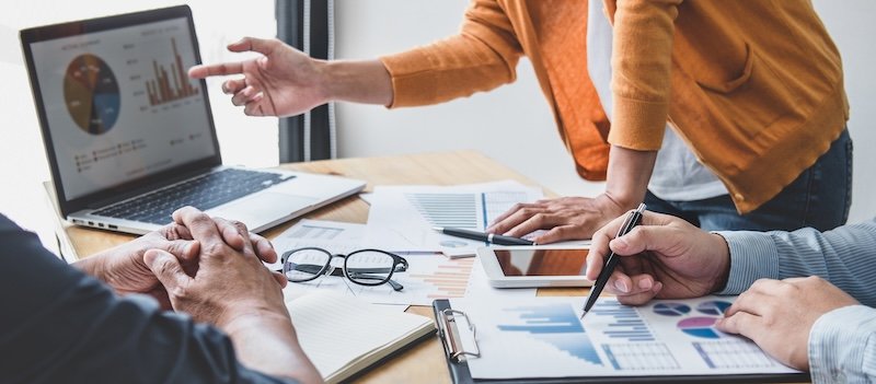 Business team collaboration discussing working analyzing with financial data and marketing growth report graph in team, presentation and brainstorming to strategy planning making profit of company.